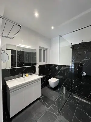 a bathroom with a sink and a shower and a toilet at Kyra Maria in Rhodes Town
