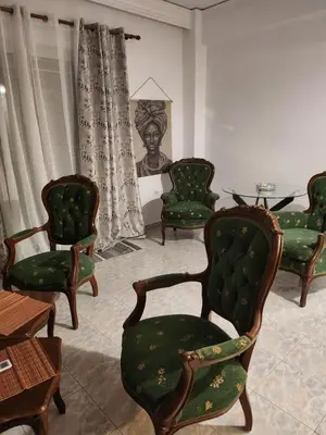 a living room with green chairs and a table at House ROSI in Rodos city in Rhodes Town