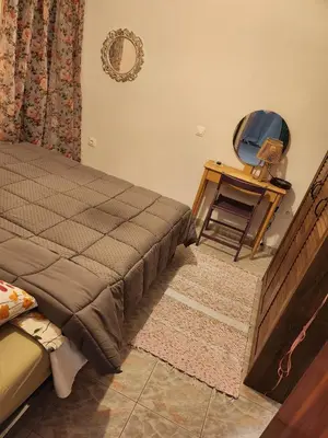a bedroom with a bed and a chair in it at House ROSI in Rodos city in Rhodes Town