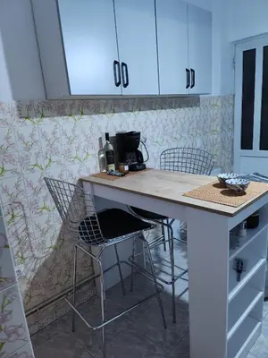 a kitchen with a counter and chairs in a room at House ROSI in Rodos city in Rhodes Town