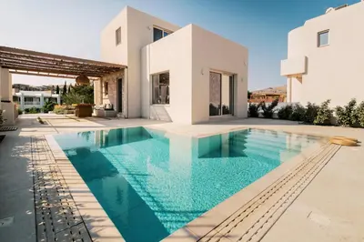 a swimming pool in the backyard of a villa at 3 Villa Complex in Kiotari
