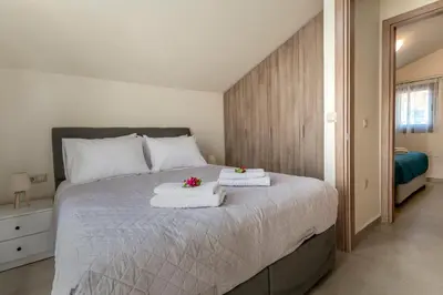 a bedroom with a bed with two towels on it at Villa Hodaj in Afantou