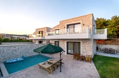 a villa with a swimming pool and a house at Villa Hodaj in Afantou