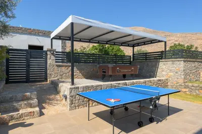 a ping pong table with a canopy on a patio at Villa Lambis Harmonia in Líndos