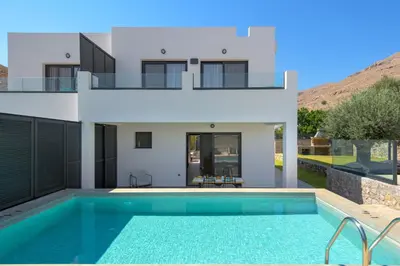 a villa with a swimming pool in front of a house at Villa Lambis Harmonia in Líndos