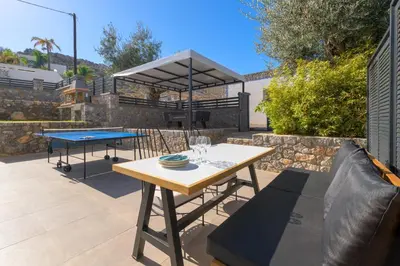 a patio with a ping pong table and a ping pong table at Villa Lambis Athena in Líndos