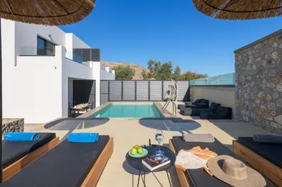 a villa with a swimming pool and a house at Villa Lambis Athena in Líndos