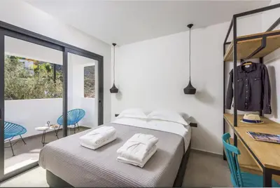 a bedroom with a bed with two towels on it at Villa Lambis Athena in Líndos