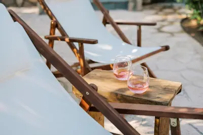 two glasses of wine sitting on a wooden table at La Casetta della Nonna in Lardos