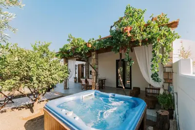 a hot tub in the backyard of a house at La Casetta della Nonna in Lardos