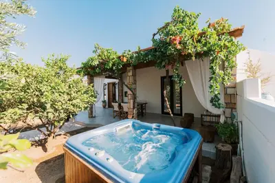 a jacuzzi tub in the backyard of a house at La Casetta della Nonna in Lardos