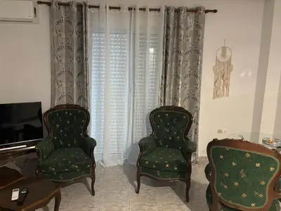 two chairs and a television in a living room at Rosi Rhodos in Rhodes Town