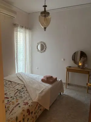 a bedroom with a bed and a mirror on the wall at Haus Rosi in Rhodes Town