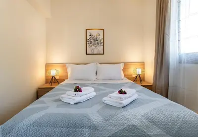 a bedroom with a bed with towels on it at Villa Hodaj 2 in Afantou