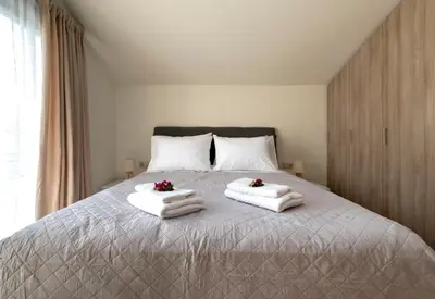 a bedroom with a bed with towels on it at Villa Hodaj 2 in Afantou