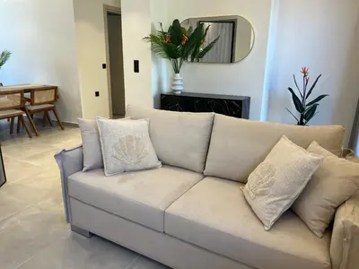 a couch with pillows in a living room at Triekmo Pyr in Rhodes Town