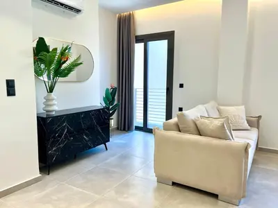 a living room with a couch and a table at Triekmo Pyr in Rhodes Town
