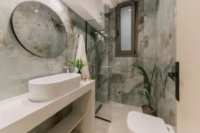 a bathroom with a sink and a mirror at Triekmo Pyr in Rhodes Town