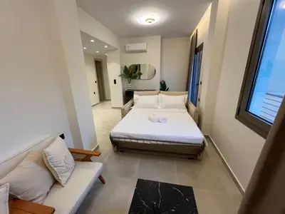 a small bedroom with a bed and a couch at Triekmo Pyr in Rhodes Town