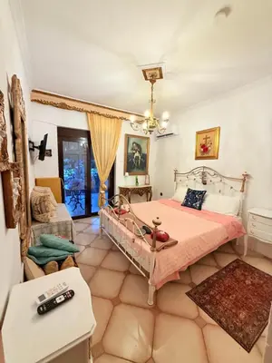 a bedroom with a bed and a living room at Popis Maison in Rhodes Town