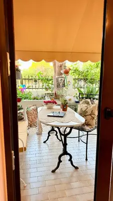 a room with a table and a view of a patio at Popis Maison in Rhodes Town