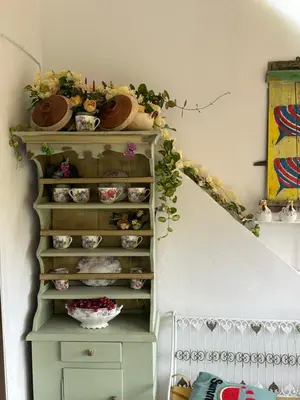 a shelf with bowls and plates on it next to a staircase at Popis Maison in Rhodes Town