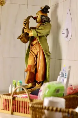 a statue of a man drinking from a pipe at Popis Maison in Rhodes Town