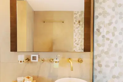 a bathroom with a mirror and a sink and a toilet at Mythica Luxury Villa in Yennadhion