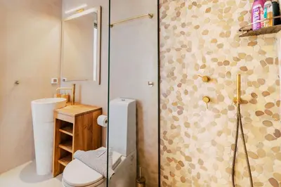 a bathroom with a toilet and a glass shower at Mythica Luxury Villa in Yennadhion