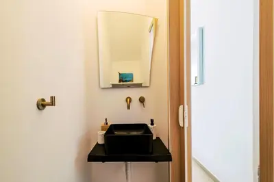 a bathroom with a black sink and a mirror at Mythica Luxury Villa in Yennadhion