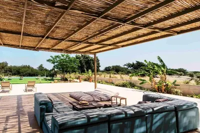 a patio with a couch and a table at Mythica Luxury Villa in Yennadhion
