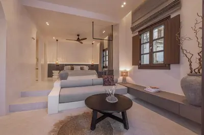 a living room with a bed and a table at Kantouni Lindos ELEGANT APARTMENT in Líndos
