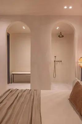 a bedroom with a bed and a bath room at Kantouni Lindos ELEGANT APARTMENT in Líndos
