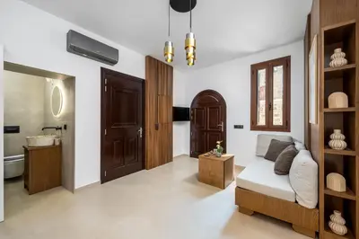 a living room with a couch and a bathroom at Aroha Apartments in Rhodes Town