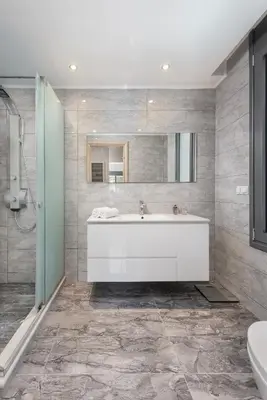 a bathroom with a white tub and a mirror at Kiotari Dream beachfront villa in Gennadi