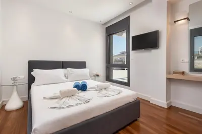 a bedroom with a bed with two towels on it at Kiotari Dream beachfront villa in Gennadi
