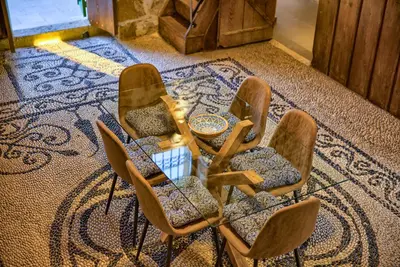 a group of chairs with a table in a room at Casa Famiglia 1910 in Malona Village
