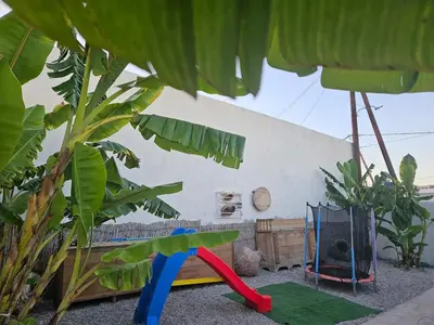 a backyard with a play area with a playground at Casa Famiglia 1910 in Malona Village