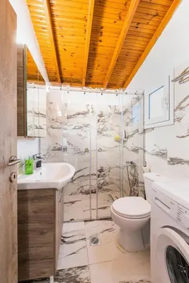 a bathroom with a toilet and a sink at Casa Olive Gennadi in Gennadi