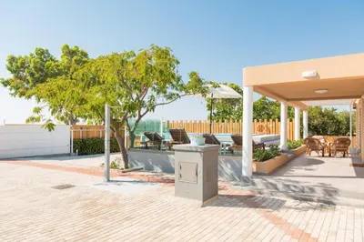 a pavilion with a table and chairs on a patio at Casa Olive Gennadi in Gennadi