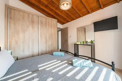 a bedroom with a bed with a large wooden wall at Casa Olive Gennadi in Gennadi