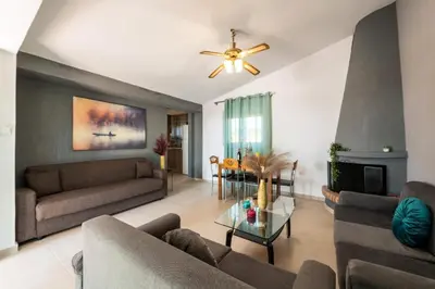 a living room with two couches and a fireplace at Casa Olive Gennadi in Gennadi