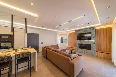 a living room with a couch and a table at Villa Askim Evelia by Villa Plus in Ialyssos