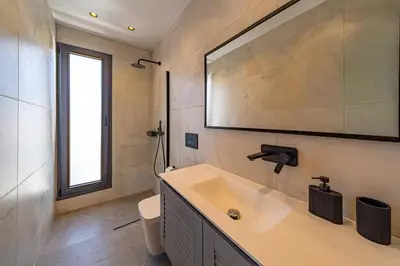 a bathroom with a sink and a toilet at Villa Askim Evelia by Villa Plus in Ialyssos