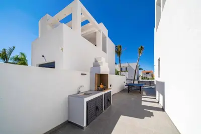 a white house with a sink in a courtyard at Villa Askim Evelia by Villa Plus in Ialyssos