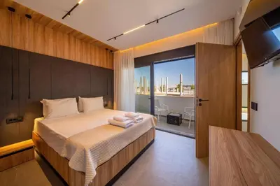 a bedroom with a large bed with towels on it at Villa Askim Evelia by Villa Plus in Ialyssos