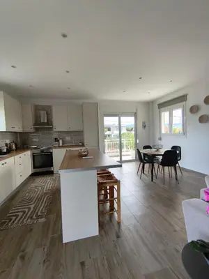 a kitchen and dining room with a table and chairs at kiki and cocos beach house in Theologos