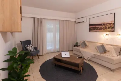 a living room with a couch and a table at Residence City Cozy Nest in Rhodes Town
