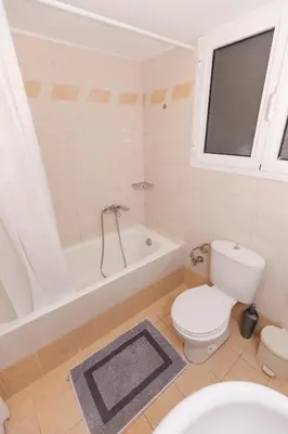 a bathroom with a toilet and a bath tub at Residence City Cozy Nest in Rhodes Town