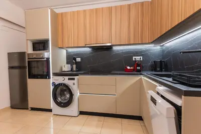 a kitchen with a washing machine and a washer at Residence City Cozy Nest in Rhodes Town